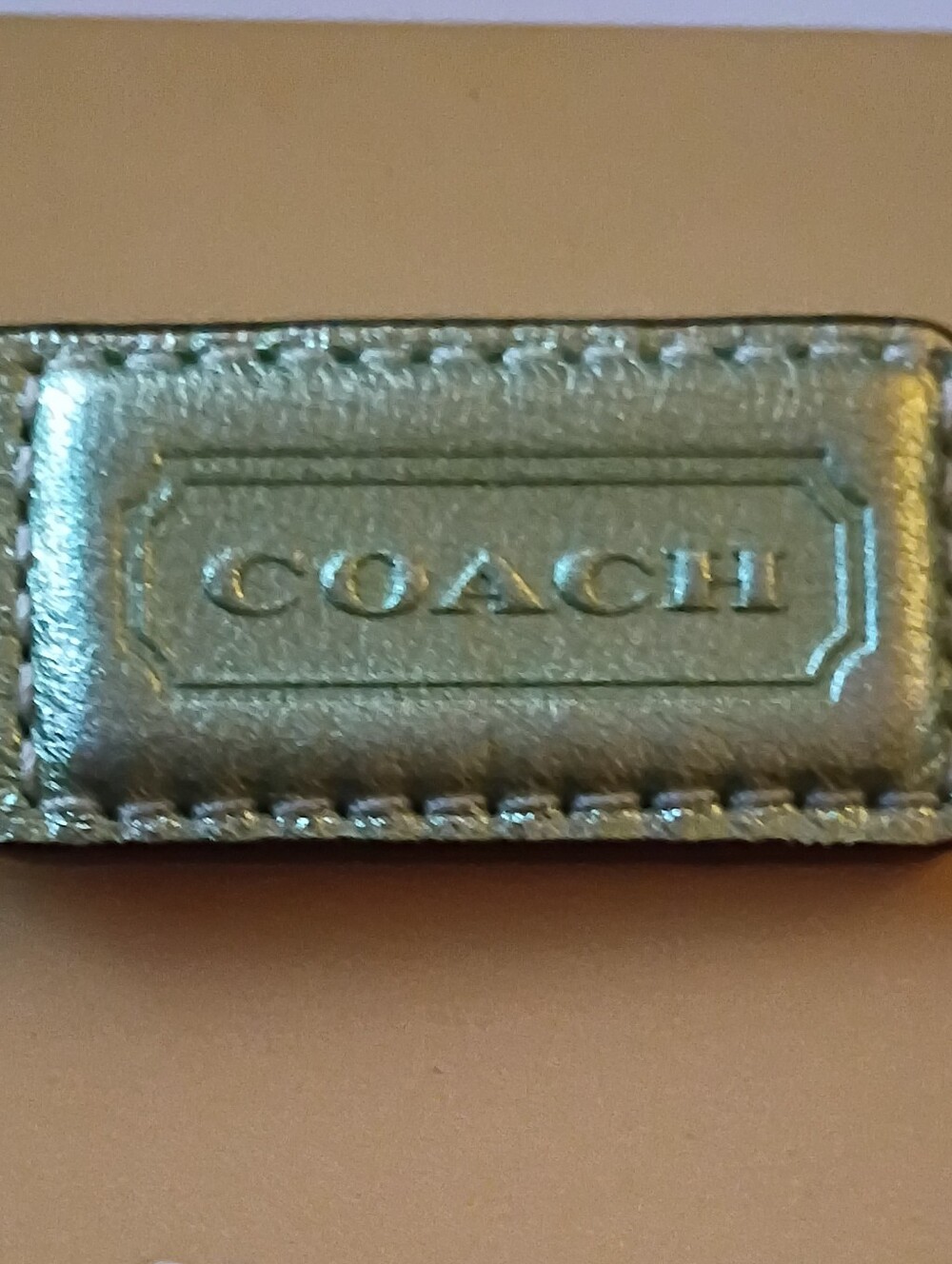 COACH Metallic Silver Leather Key Tag with Embossed Logo